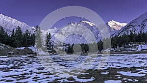 Snow cap Nanga Parbat mountain with sunset light up and snow frost on the ground at Fairy meadows