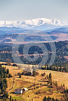 Snow caped mountains in sunny spring day.