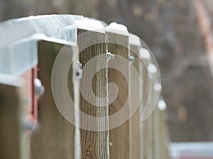 Snow caped Posts on a bridge photo