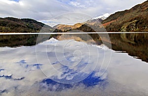 Snow caped Yr Aran and winter coloured snowdonia foothills reflected in Llyn Gwynant