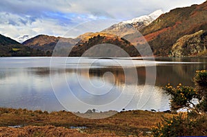 Snow caped Yr Aran and winter colours of snowdonia foothills reflected in Llyn Gwynant