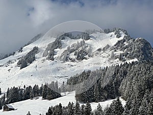 Snow-capped alpine peak Raaberg 1723 m, easternmost summit of the Mattstock massiv and above the Lake Walen or Lake Walenstadt