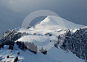 Snow-capped alpine peak Schofwisspitz 1989 m in Alpstein mountain range and in Appenzell Alps massif, Unterwasser