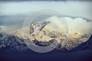 Snow capped mount kanchenjungha from Darjeeling India with sunrise colours and moody clouds