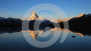 Snow capped Mount Matterhorn mirroring in Lake Stellisee