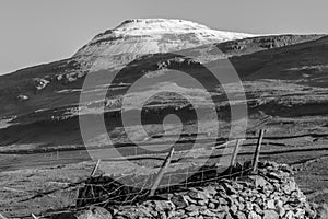 Snow capped mountain with farm land in black and white