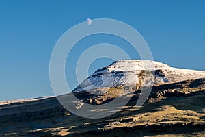 Snow capped mountain with the moon
