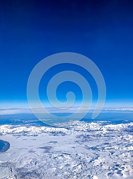 Snow capped mountain range against blue skies