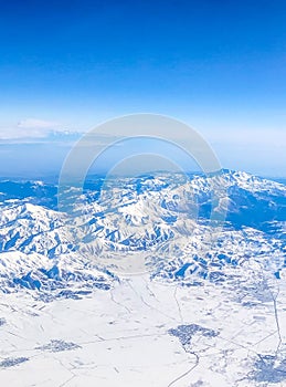 Snow capped mountain range against blue skies