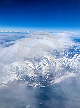 Snow capped mountain range against blue skies