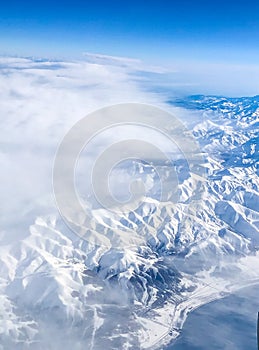 Snow capped mountain range against blue skies