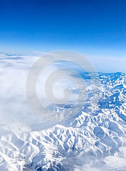 Snow capped mountain range against blue skies