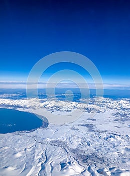 Snow capped mountain range against blue skies