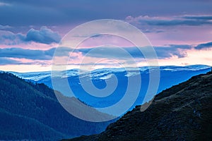 Snow-capped mountain range at sunset