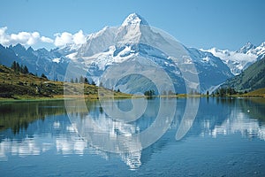 A snow-capped mountain reflected in a crystal-clear lake