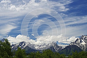 Snow capped mountains above a clear blue lake in Yellowstone.