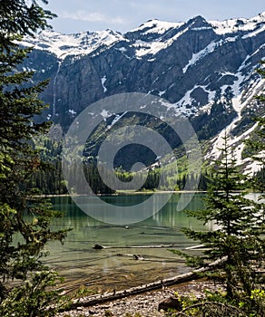 Snow capped mountains and clear lake