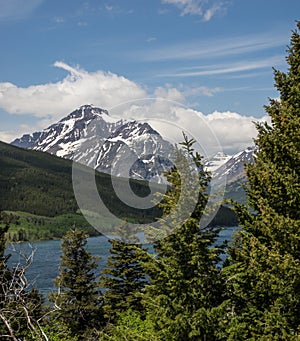 Snow capped mountains and clear lake