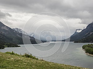 Snow capped mountains and clear lake