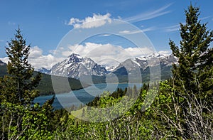 Snow capped mountains and clear lake