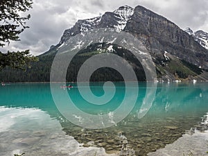 Snow capped mountains and clear lake