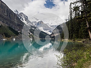 Snow capped mountains and clear lake