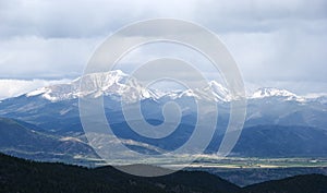 Snow Capped Mountains Shrouded in Storm Clouds photo