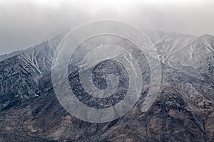 Snow capped mountaintops covered in clouds near Bishop, California, USA