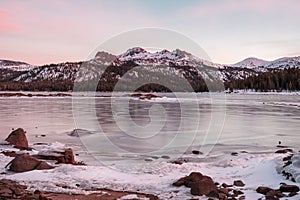 A snow capped peak with sunset colors