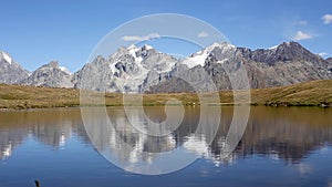 Snow-capped peaks of the Caucasus reflecting in the lake