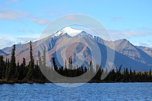 SNOW CAPPED ROCKY MOUNTAIN BLUE LAKE FORREST AND BLUE SKY