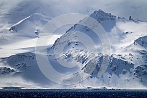 Snow capped and windblown snow of Elephant Island in Antarctica photo