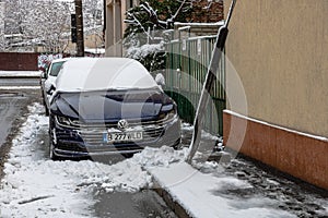 Snow on cars in the morning. Winter season  icy cars. Winter concept  frozen cars on the road in Bucharest  Romania  2021