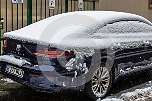 Snow on cars in the morning. Winter season  icy cars. Winter concept  frozen cars on the road in Bucharest  Romania  2021