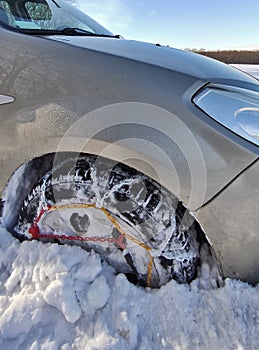 Snow chain on a wheel in deep snow in winter