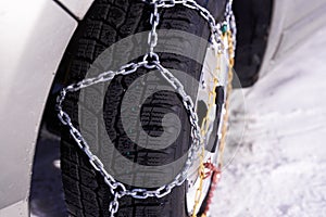 Snow chain on a wheel in deep snow in winter