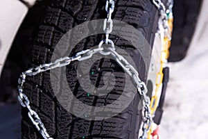 Snow chain on a wheel in deep snow in winter