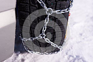 Snow chain on a wheel in deep snow in winter