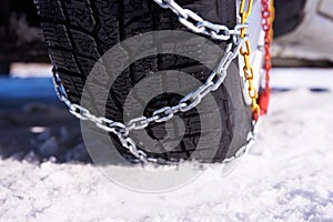 Snow chain on a wheel in deep snow in winter