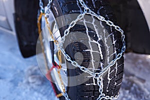 Snow chain on a wheel in deep snow in winter