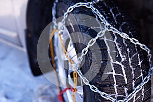 Snow chain on a wheel in deep snow in winter