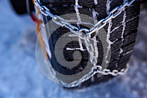 Snow chain on a wheel in deep snow in winter