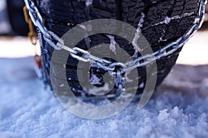 Snow chain on a wheel in deep snow in winter