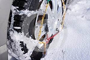 Snow chain on a wheel in deep snow in winter