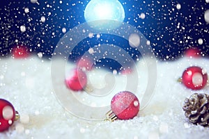 Snow christmas magic lights background. Christmas card with a winter forest and christmas decorations in a moonlit night. The elem