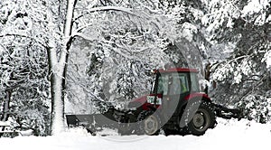 Snow cleaning tractor clears paths