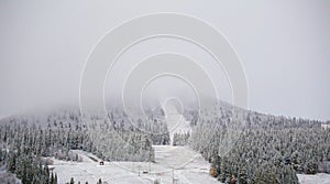 Snow and clouds obscure the view on the mountain Hovaerken in Sweden