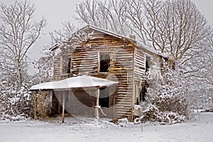 Snow covered abandoned house