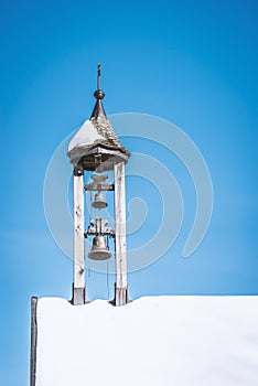 Snow covered alpine chapel tower