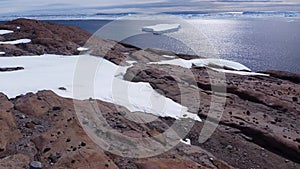 Snow covered antarctic surface aerial view flight.